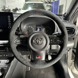 Toyota GR Yaris (2020-2025) Steering Wheel Wrap – Black Alcantara, Black stitch, Red Holo-stripe marker