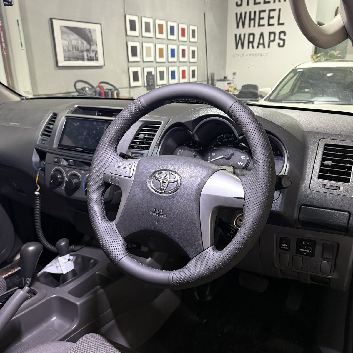 Toyota HiLux 7th Gen (2005–2015) Steering Wheel Wrap – Black Leather (smooth top, perforated sides), Black stitch